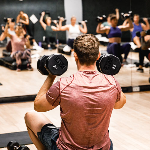 Man with dumbbells in conditioning class, conditioning classes santa barbara