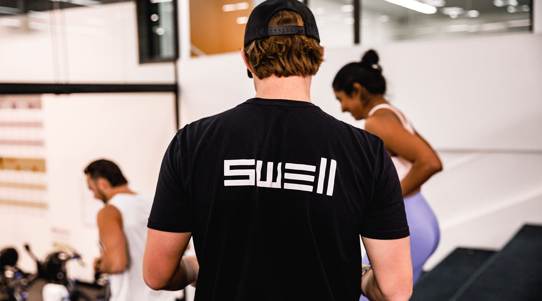 swell santa barbara logo on trainer's shirt