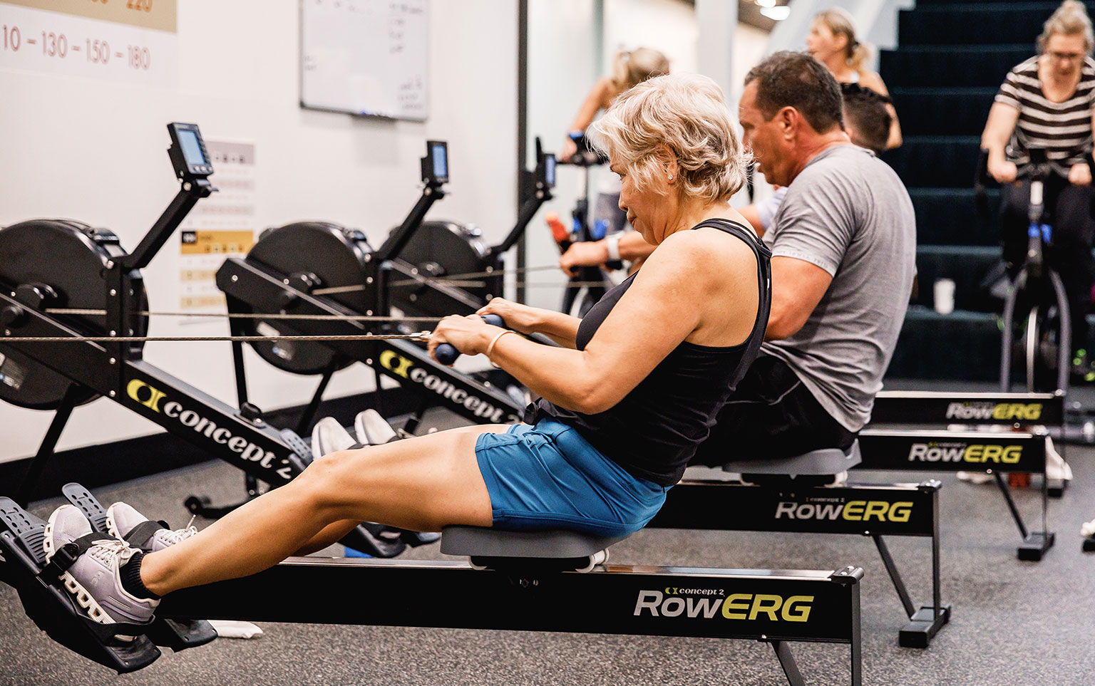 Older woman on row machine in gym for a blog about stroke prevention