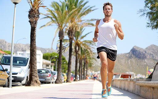 a man running outside with proper equipment and form thanks to these running tips for beginners